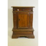 A late C18th/early C19th Italian carved walnut credenza with frieze drawer and single panel door, on