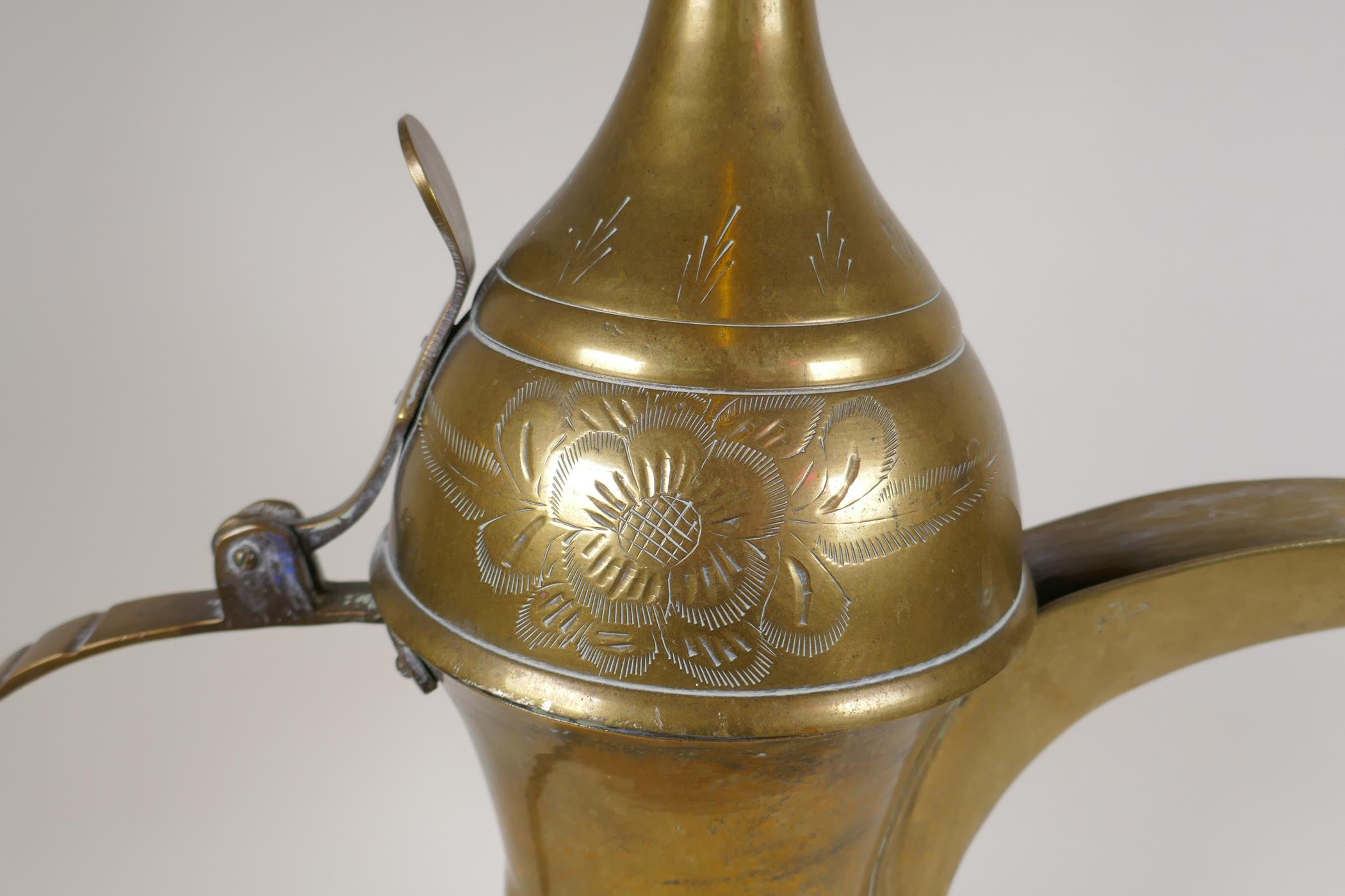 A Turkish brass coffee pot with chased floral decoration, 23½" high - Image 7 of 8