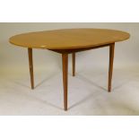 A mid century Austin-Suite teak drawleaf dining table with extra fold out leaf, 44" diameter, 59"