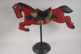 A carved and painted model of a fairground horse, 23" long