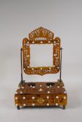 A C19th horn mounted dressing table stand with a swing mirror frame and carved detail,  9" x 6½",