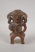 A pre-Columbian painted terracotta figure, 7" high