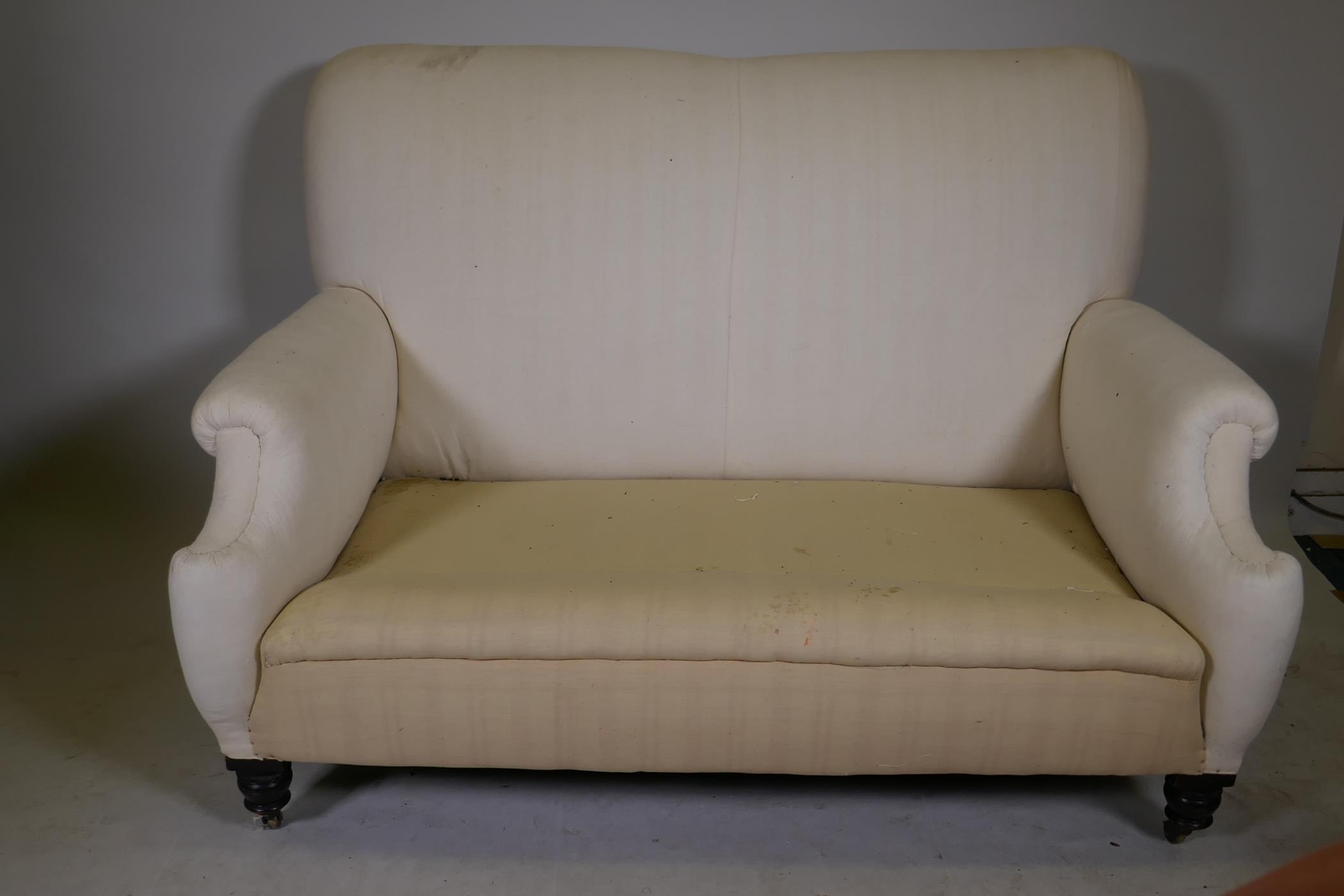 A C19th two seater Howard style settee, raised on turned supports with brass castors, the back - Image 2 of 5