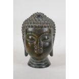 A Sino Tibetan bronze Buddha head, 7½" high