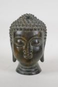 A Sino Tibetan bronze Buddha head, 7½" high