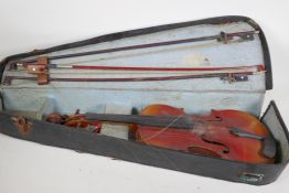 A vintage French violin with one piece back by J.T.L., 24" long, in a case with three bows