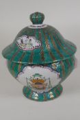 A Continental porcelain jar and cover with panels decorated with coats of arms, on a green and