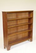 A mahogany open bookcase, fitted with four adjustable shelves, raised on bracket supports, 48" x 12"