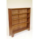 A mahogany open bookcase, fitted with four adjustable shelves, raised on bracket supports, 48" x 12"