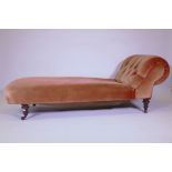 An early C19th chaise longue, raised on turned and fluted supports with brass castors, 72" x 28" x