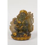 A Sino Tibetan moulded smoked glass figure of a wrathful deity, with gilt highlights, 4" high
