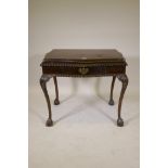 A mahogany silver/side table, with single drawer and serpentine shaped top with gadrooned edge,