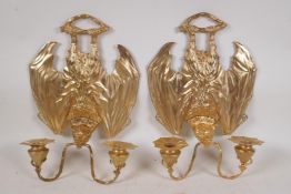 A pair of gothic style ormolu two branch wall sconces in the form of vampire bats, 9½" x 13½"