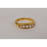 An 18ct gold ring set with five seed pearls, 2.5g