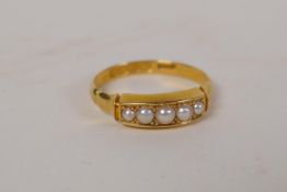 An 18ct gold ring set with five seed pearls, 2.5g
