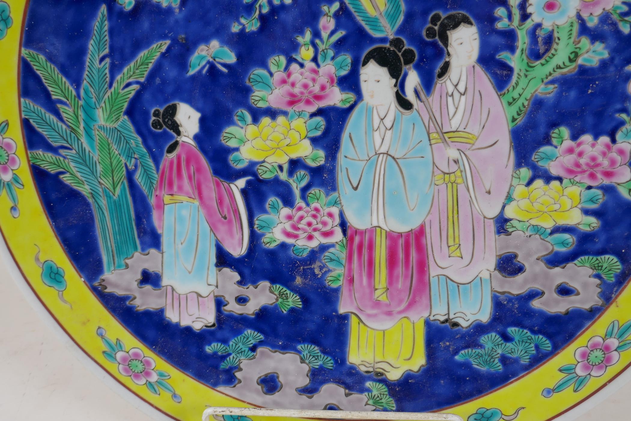 A Chinese porcelain charger painted in bright enamels with a lady and her servants, 16" diameter - Image 2 of 3