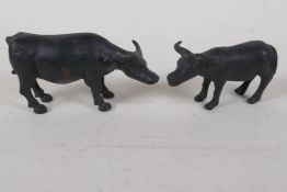 A pair of bronzed metal figures of oxen, largest 5" long