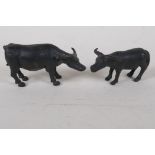 A pair of bronzed metal figures of oxen, largest 5" long