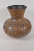An African earthenware storage jar with scafito decoration, 12" high, AF