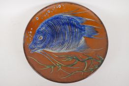 A large studio pottery charger with tube liner and painted decoration of a fish, signed, 13½"