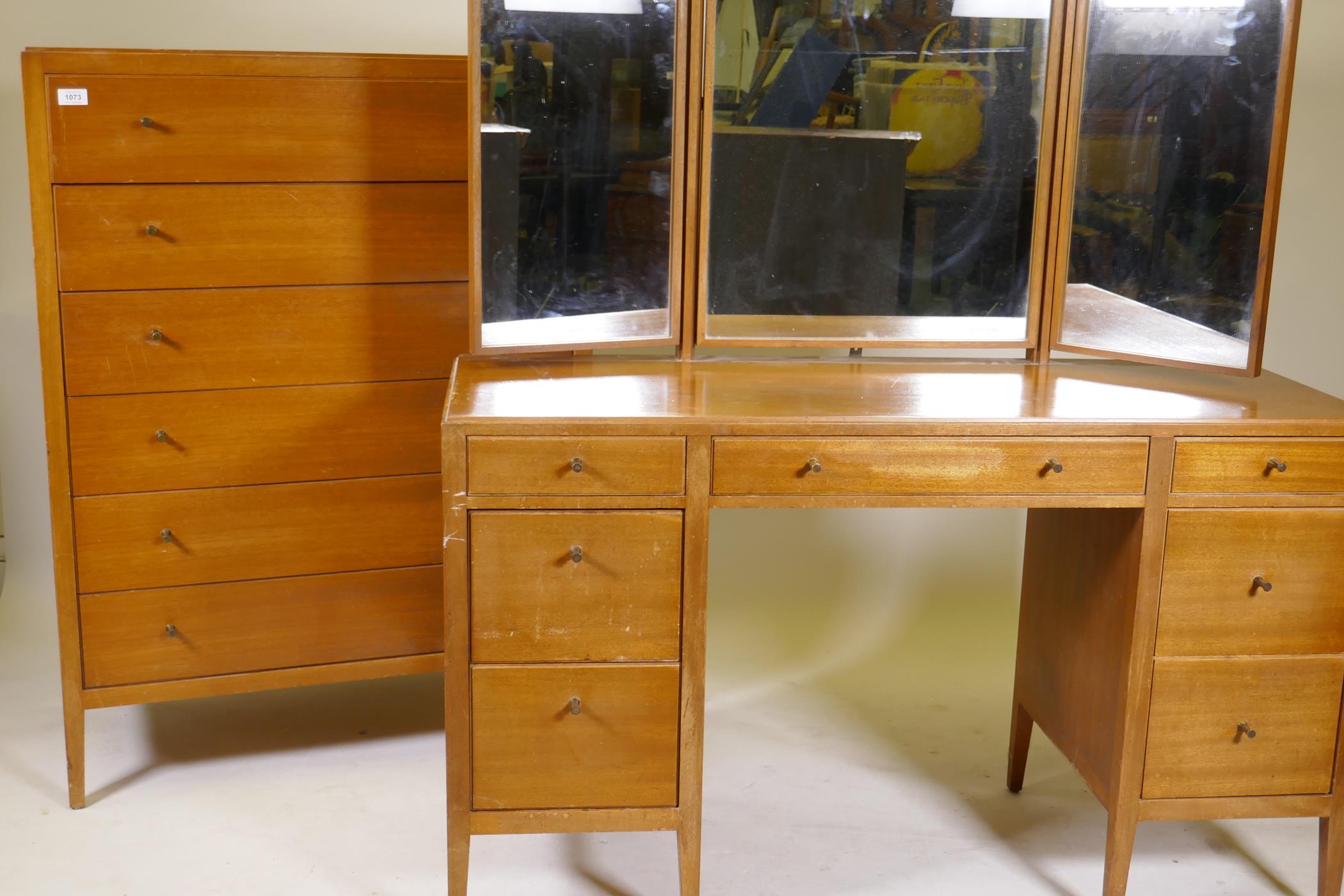 A mid century Loughborough for Heals tall chest of six drawers and a matching dressing table,