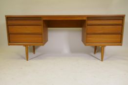 A mid century Austin-Suite kneehole dressing table, with six drawers and leatherette covered