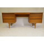 A mid century Austin-Suite kneehole dressing table, with six drawers and leatherette covered