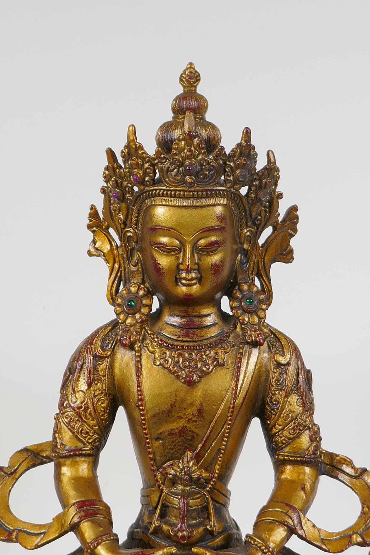 A Sino Tibetan gilt bronze figure of Buddha seated on a lotus throne, 14½" high - Image 2 of 3