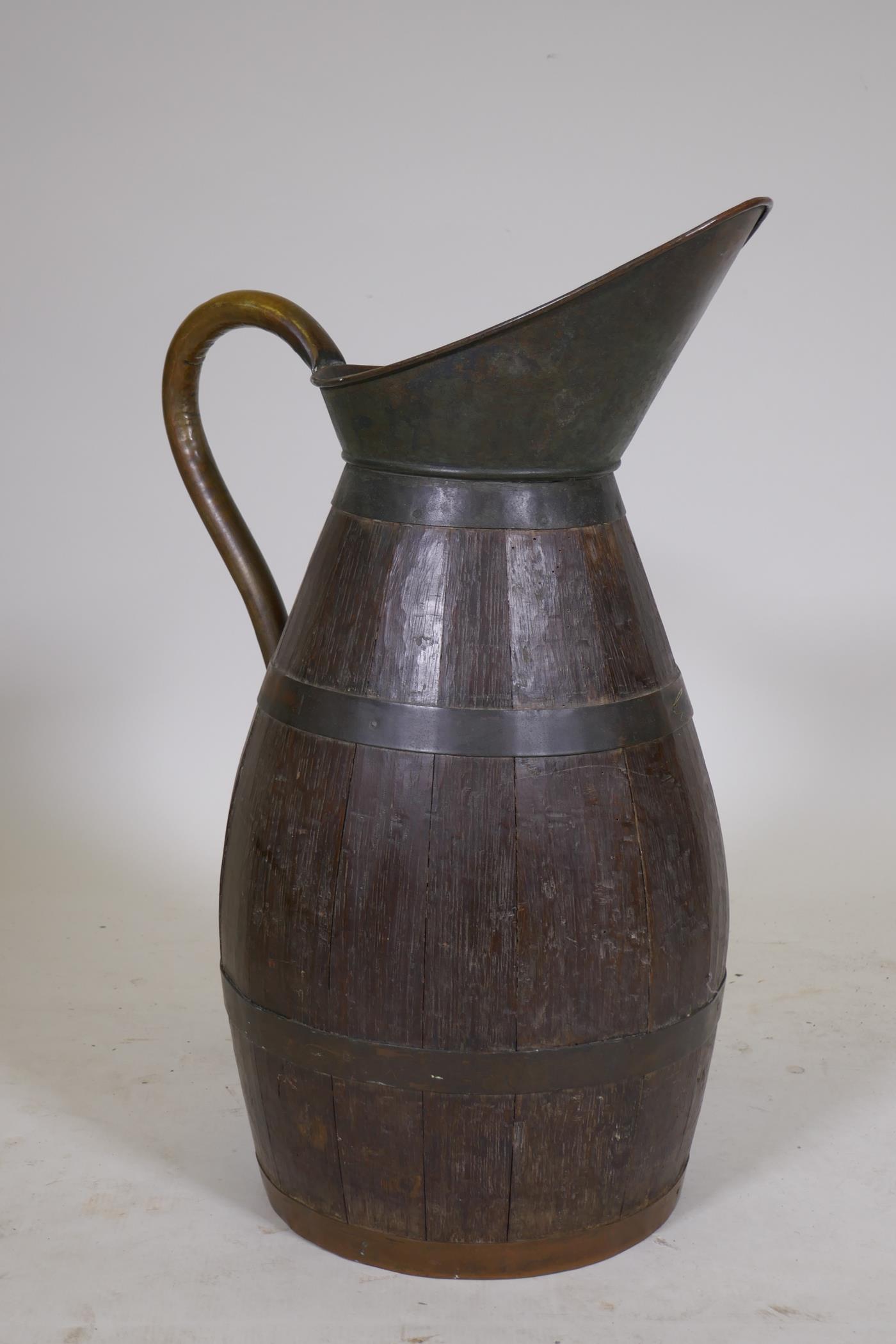 An antique coopered oak pitcher with brass handle, 23" high - Image 3 of 3