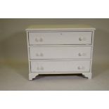 A painted pine chest of three long drawers, raised on bracket supports, 36" x 17" x 30"