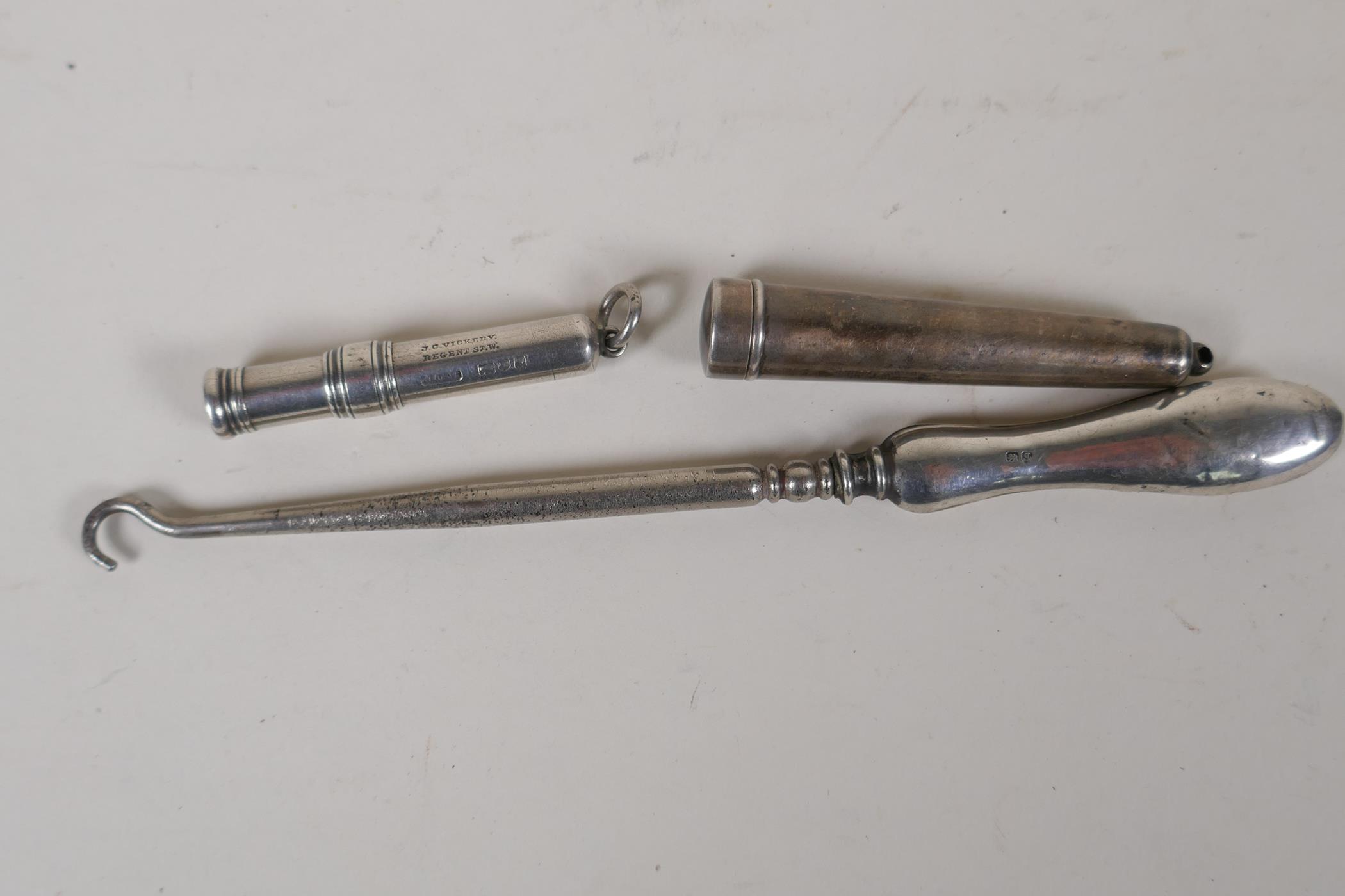 A hallmarked silver chatelain pencil, a hallmarked needle case and a hallmarked silver handled