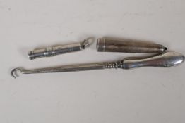 A hallmarked silver chatelain pencil, a hallmarked needle case and a hallmarked silver handled