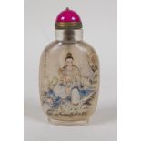 A Chinese reverse decorated glass snuff bottle depicting Quan Yin seated on a mythical creature,