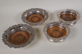 A pair of C19th Sheffield plated bottle coasters, the rims with applied and engraved decoration of