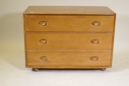 A 1060s/70s Ercol elm chest of three long drawers, 36" x 19" x 28" high