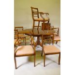 G.T. Rackstraw, a yew wood dining table with extra leaf, raised on turned column reeded splay