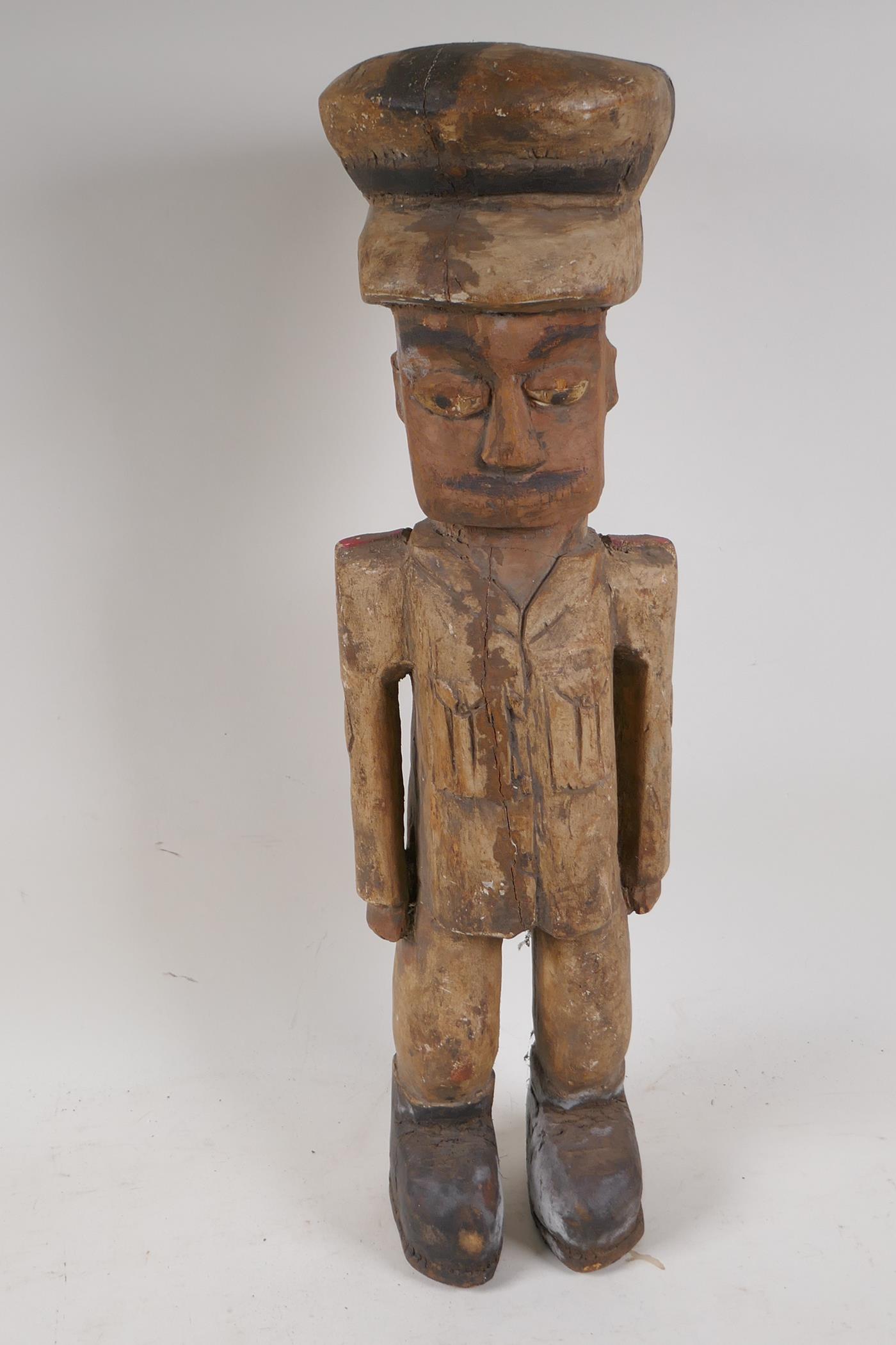 A carved wood figure of a soldier, 20" high