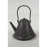 A Japanese Edo period iron teapot (Tetsubin) of Mount Fuji form, embossed with dragons and