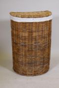 A wicker laundry basket, 31" high