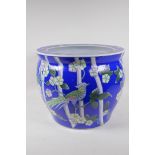 A Chinese blue ground ceramic jardiniere with famille rose decoration of asiatic birds and