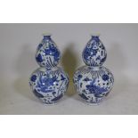 A pair of Chinese blue and white porcelain double gourd vases decorated with carp in a lotus pond,