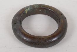 An engraved bronze manilla, 7" diameter, 3.3kg