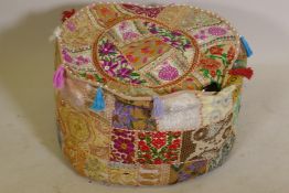 An Indian extensively embroidered pouffe, 20" diameter