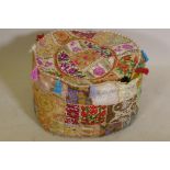 An Indian extensively embroidered pouffe, 20" diameter