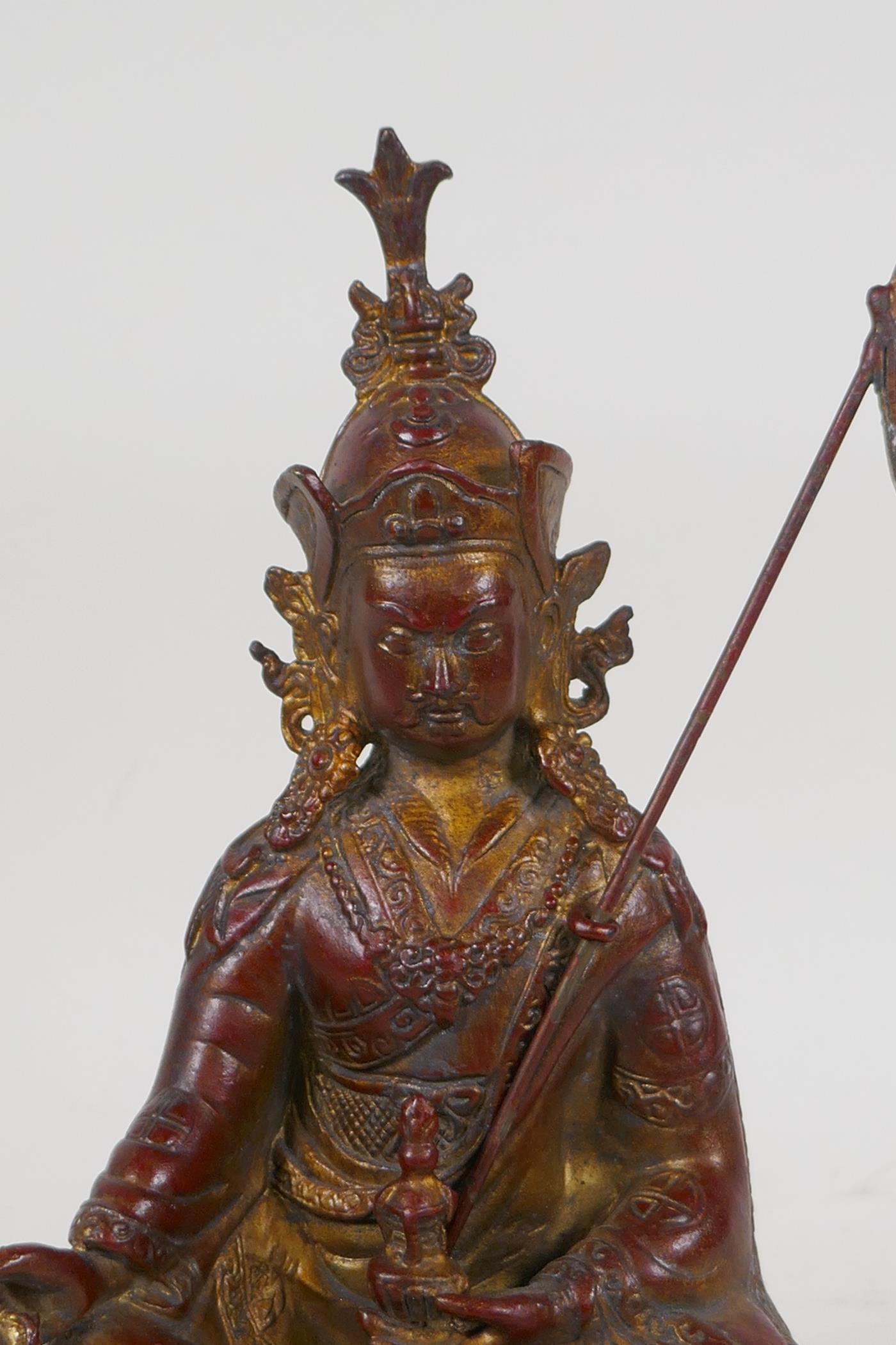 A Sino Tibetan gilt and coppered bronze figure of Buddha seated and holding a vajra, 10½" high - Image 2 of 4