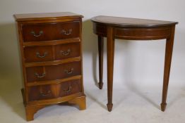 A yew wood serpentine front chest of four drawers, 20" x 15" x 32", and a mahogany demi-lune console