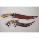 An Eastern dagger with bone handle and engraved blade in metal tipped leather scabbard, 15" long,