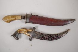 An Eastern dagger with bone handle and engraved blade in metal tipped leather scabbard, 15" long,