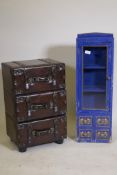 A chest of three drawers in the form of stacked leather suitcases, and a painted cabinet with glazed