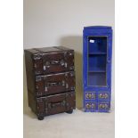 A chest of three drawers in the form of stacked leather suitcases, and a painted cabinet with glazed